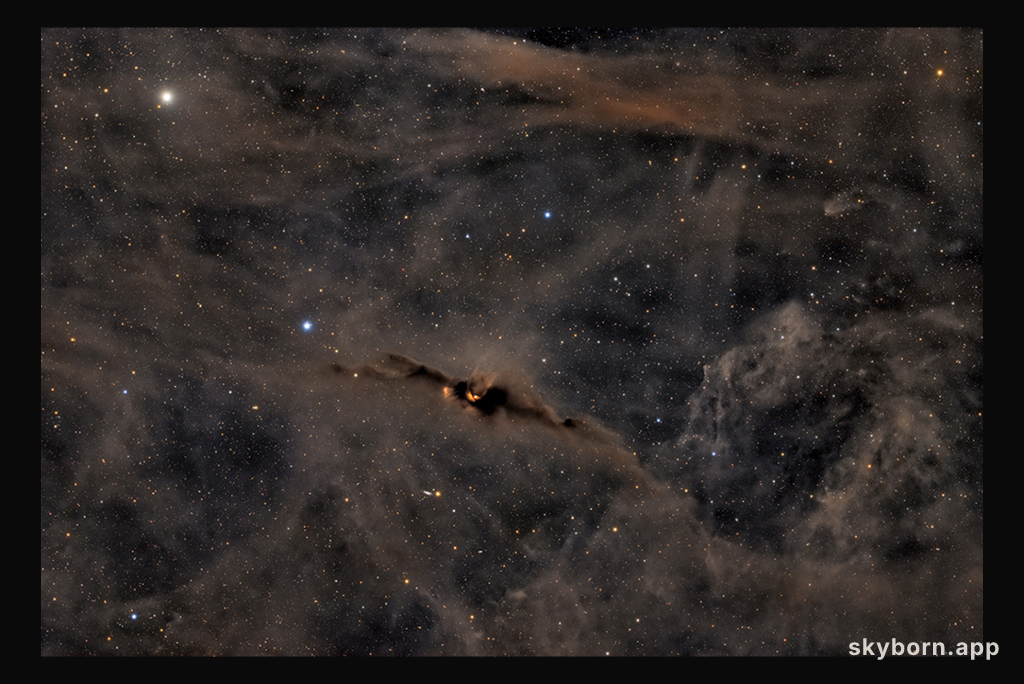 The Red Glow of the Cosmic Bat Nebula
